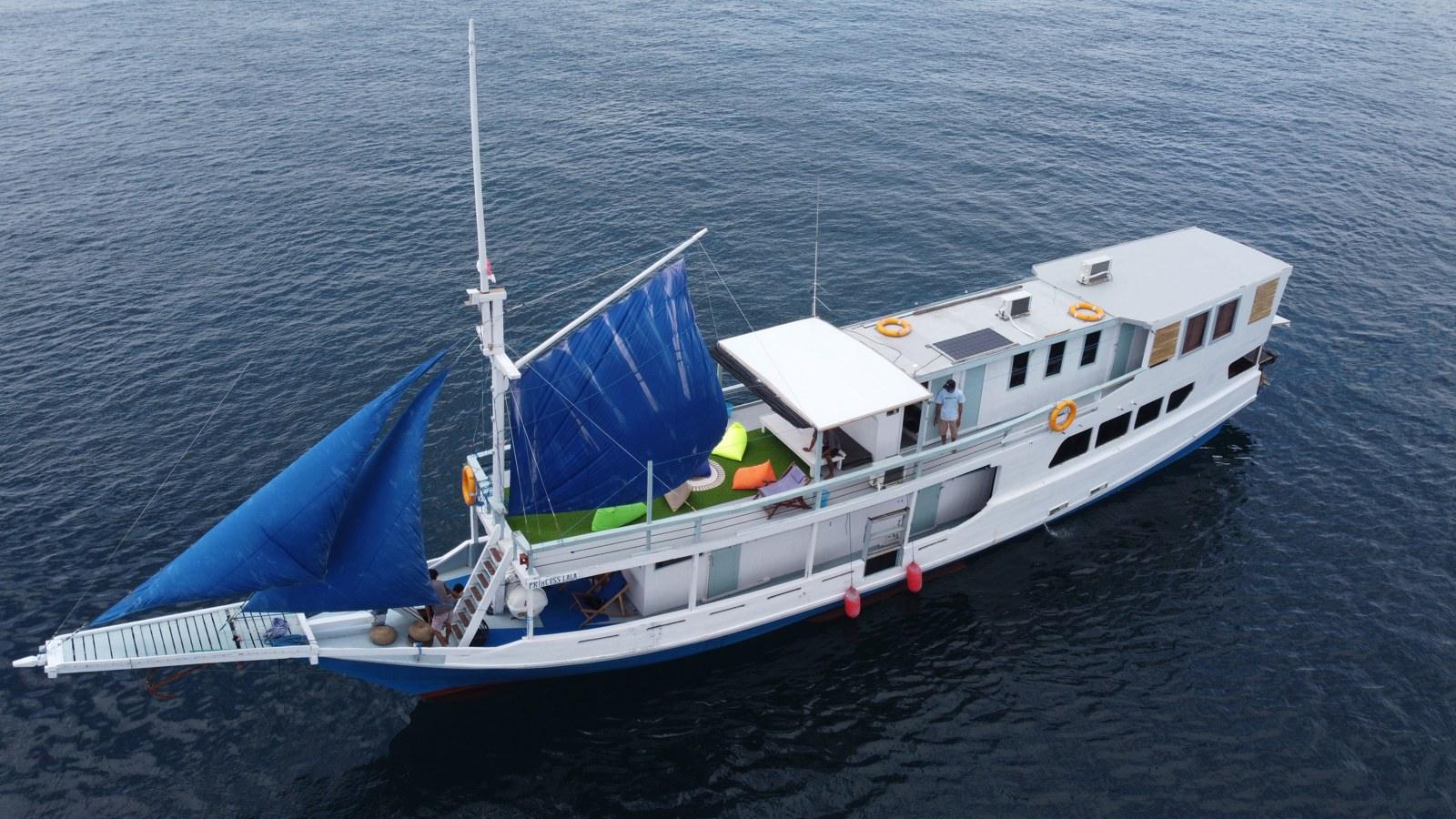 Princess Lala phinisi from the air with both blue sails set