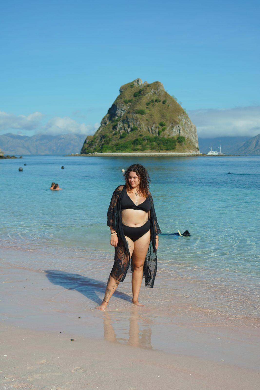 Kelor – woman in black cover-up on sand, islet (Real photo from a Komodo Explorer trip)