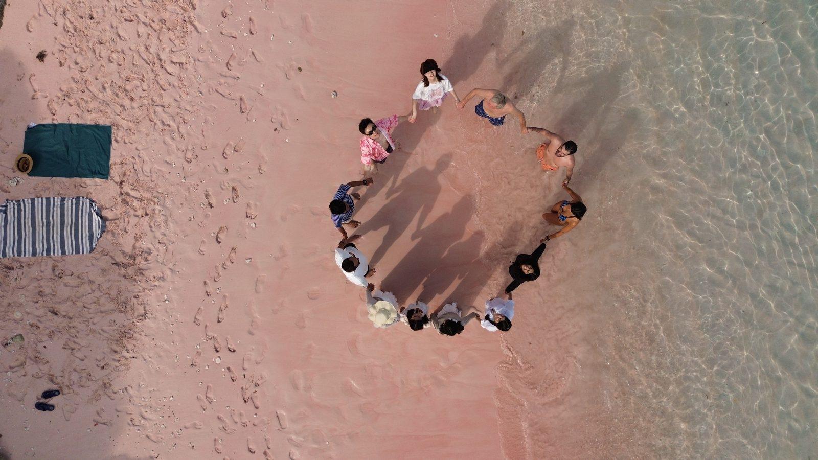 Pink Beach – Aerial group circle on pink sand (Real photo from a Komodo Explorer trip)