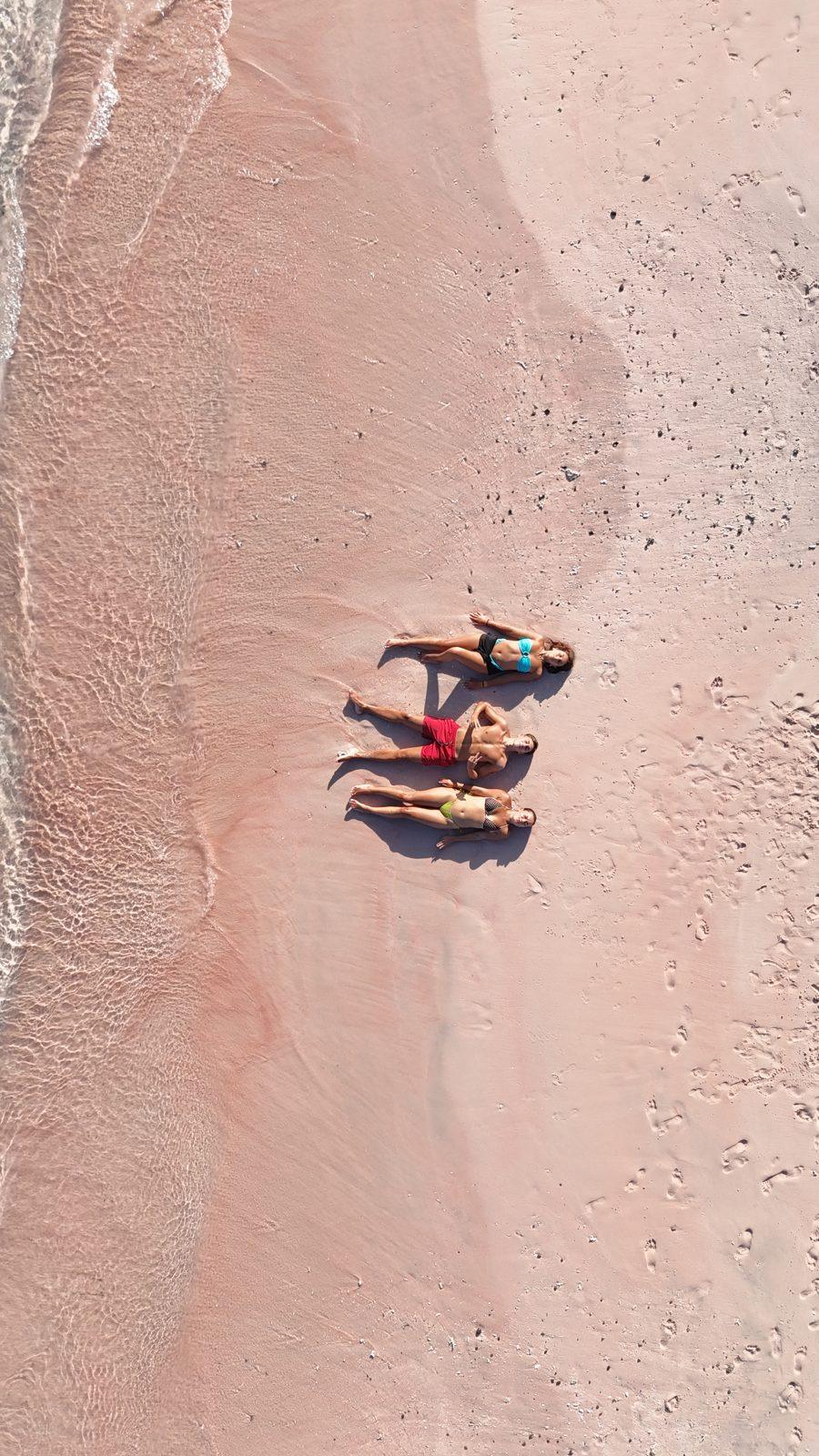 Pink Beach – two people lying on pink sand strip (Real photo from a Komodo Explorer trip)