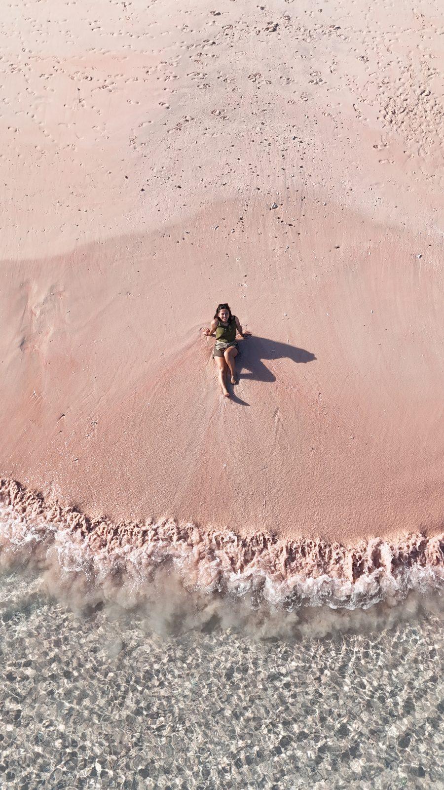 Pink Beach – lone figure on pink sand, turquoise water (Real photo from a Komodo Explorer trip)